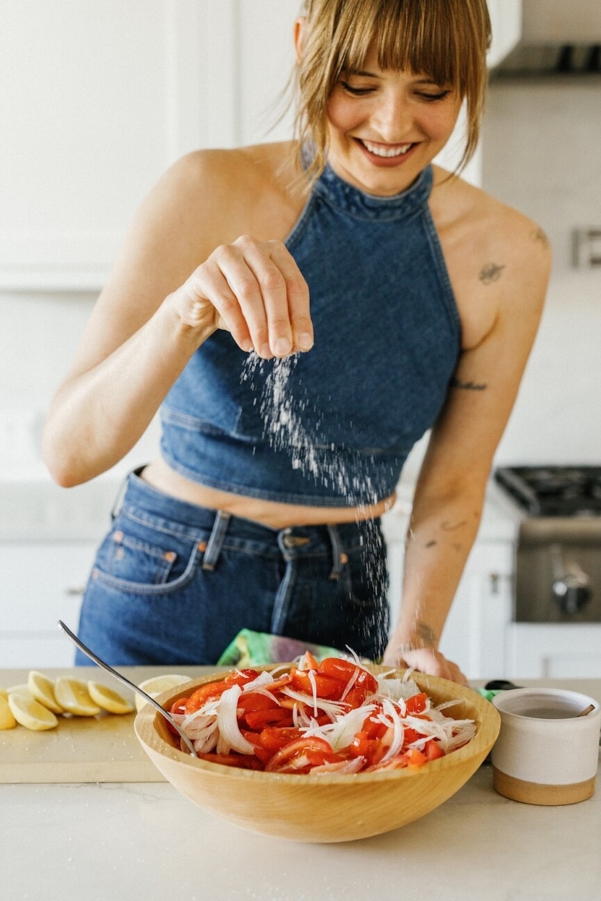 Salt sprinkled on tomato salad recipe.