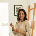 Woman applying facial skin serum.