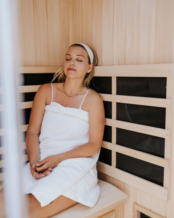 Woman sitting in sauna